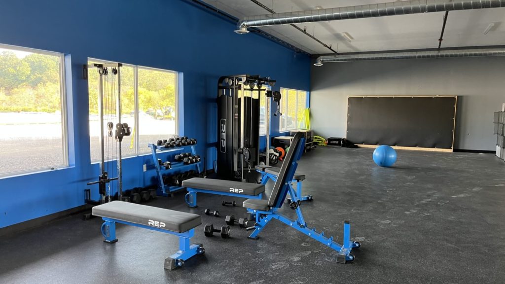 Clean and new gym interior, showing gym equipment and open space